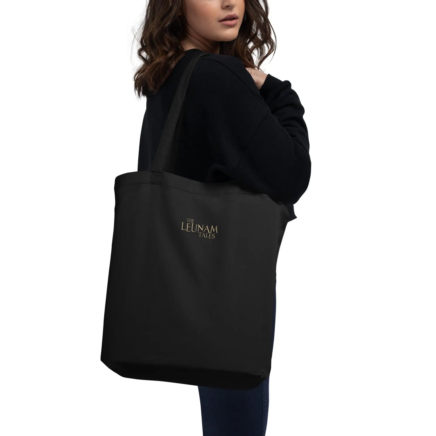 A woman carrying The Leunam Tales Tote Bag back